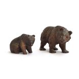 Two carved Black Forest bears, one standing on all fours, the other seated, 13cm and 9cm high