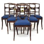 A set of six 19th century dining chairs, carved rail with parcel gilt rosette decoration, over