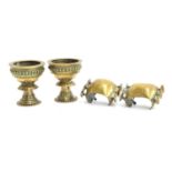 A pair of decorative Indian brass chalices, each 10.5cm high; together with a pair of unusual