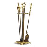 A good set of 19th century gilt metal fire tools, comprising poker, tongs, and shovel, on ornate