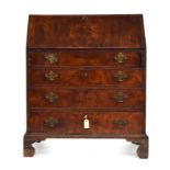 A George III mahogany bureau, the fall and drawers bookmatched, the top with the usual arrangement