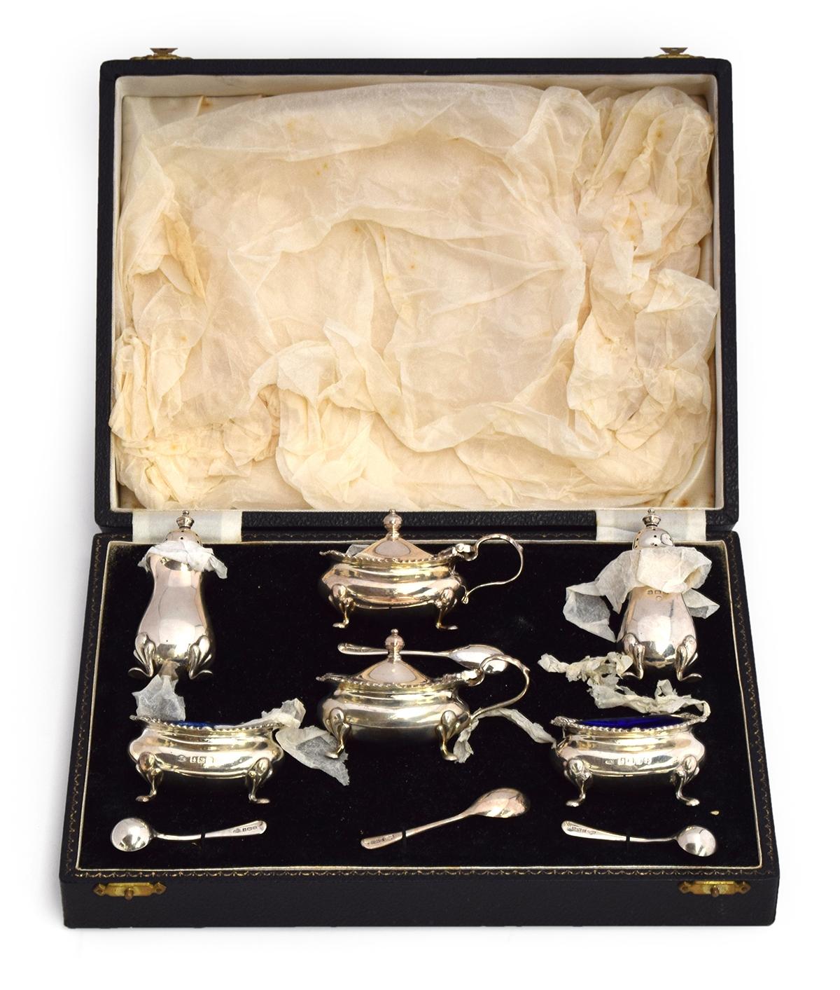 A cased matched cruet set, various makers, comprising two salts and two lidded mustards with blue