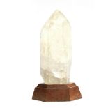A very large piece of carved quartz upon a fitted hexagonal hardwood plinth, 47.5cm high including