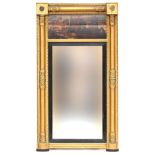 A 19th century giltwood pier mirror, oil on panel depicting depicting a folly at sunset, 132cm high,