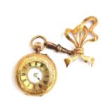 An 18ct gold ladies half hunter fob watch, 30mm diameter, attached by a gold swivel to a 14ct gold