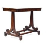 An early Victorian rosewood writing desk, bookmatched top on two reeded scrolling pedestals