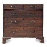 A George II oak chest of two short over three long drawers, the top with an ovolo lip, the drawers