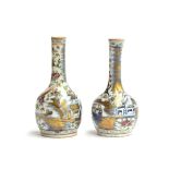 A matched pair of Chinese bottle vases, the first decorated with butterflies and dragons, 16cm high;