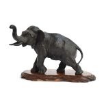 A Japanese Meiji era bronze elephant, seal mark to underside, on carved hardwood base, 22cm high