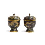 A pair of early 20th century Chinese lidded cloisonné urns, depicting dragons on a black ground