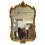 A 19th century French giltwood wall mirror with floral cresting and foliate acanthus decoration,