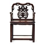 A Chinese hardwood elbow chair, the shaped back with pierced and carved peach and scroll ornament,