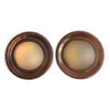 A pair of 19th century mahogany framed circular wall mirrors, the plates approximately 16.5cm