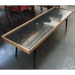 A mid-century coffee table with glass inset top, with dansette legs, 122x35x38cmH