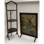 An embroidered fire screen, 65cmH; together with a folding oak three tiered cake stand, 94cmH