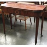 A Regency mahogany card table, with fold over top and square tapered legs with brass caps and