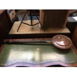 A copper long handled bed warming pan; together with a brass iron three legged trivet with turned