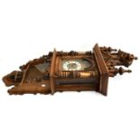 A carved oak wall clock, with pendulum and key, height including finial approx. 125cmH