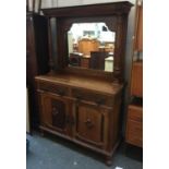 A late 19th century Chiffonier, the top with two tapered columns, shaped bevelled mirror, over a