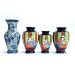 Three tube lined Japanese vases heightened in gilt; together with a blue and white floral vase,