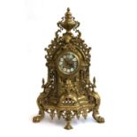 A 20th century mantel clock in a Baroque brass ormolu style case, the dial having inlaid enamel