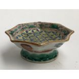 A Chinese octagonal footed bowl with 'lucky' bat symbols and floral motifs, four character marks