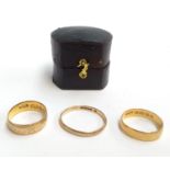 Three gold wedding bands; 22ct 2.6g (N), 18ct 3.1g (M), 9ct, 1.5g (T)