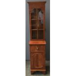 A glazed walnut bookcase on cupboard, with key,