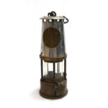 An original Davy lamp with plaque reading ' The Protector Lamp and Lighting Co. Ltd Eccles, type