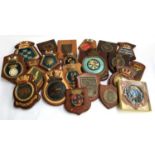 A large number of military and naval crests on wooden plaques