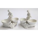 A pair of Meissen figural salts, white glazed, marks to base, each 11.5cmH