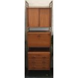 An unusual mid-century three-part unit comprising two cupboards over three drawers, teak and