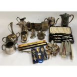 A mixed lot of plated wares to include a cased set of lobster picks, several coffee sets, a number