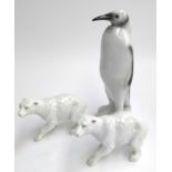 A Hollohaza porcelain penguin, hand painted with marks to base, 24.5cmH; together with two porcelain