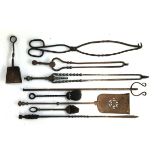 A good selection of wrought iron fire tools, to include tongs, pokers, shovels, brushes, etc (9)
