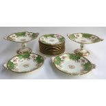 A Coalport green and gilt part dinner service to include several cake stands and a number of side