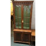 A glazed bookshelf, of three shelves above two cupboard doors, 177cmH