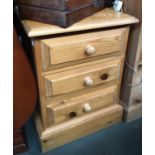A pine bedside cabinet with three drawers, 59cmH