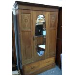 An Edwardian mahogany hanging wardrobe, with marquetry decoration, oval bevelled mirror, above