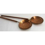A pair of very heavy copper and brass long handled skillets, 111cmL
