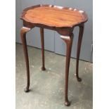 A walnut lamp table with pie crust edge, 70cmH