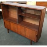 A mid century bookshelf, two sliding glass doors with sliding cupboard doors below, 122cmW