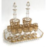 A continental glass set with two decanters heightened in gilt, with 11 Schapps glasses, on tray