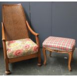 An oak open armchair, with caned back; together with a footstool