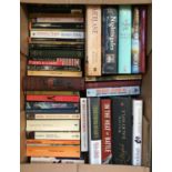 A mixed box of books, various paperbacks, some history