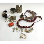 A mixed lot of costume jewellery to include large silver coloured bangles, 9ct (mark rubbed) locket,