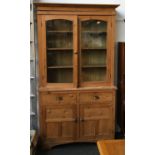 A good 19th century pine dresser, having glazed doors over a base of two drawers and two cupboard