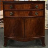 A bowfront mahogany chest of two drawers over cupboard doors, with key, 76x49x81cmH