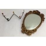 A 1950s coat rack together with a gilt framed wall mirror