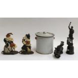 An enamelled bread bin; two cast spelter figures of blacksmiths; and two cast metal doorstops in the